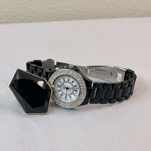 Black watch that needs a battery, and ring with gold details on the back